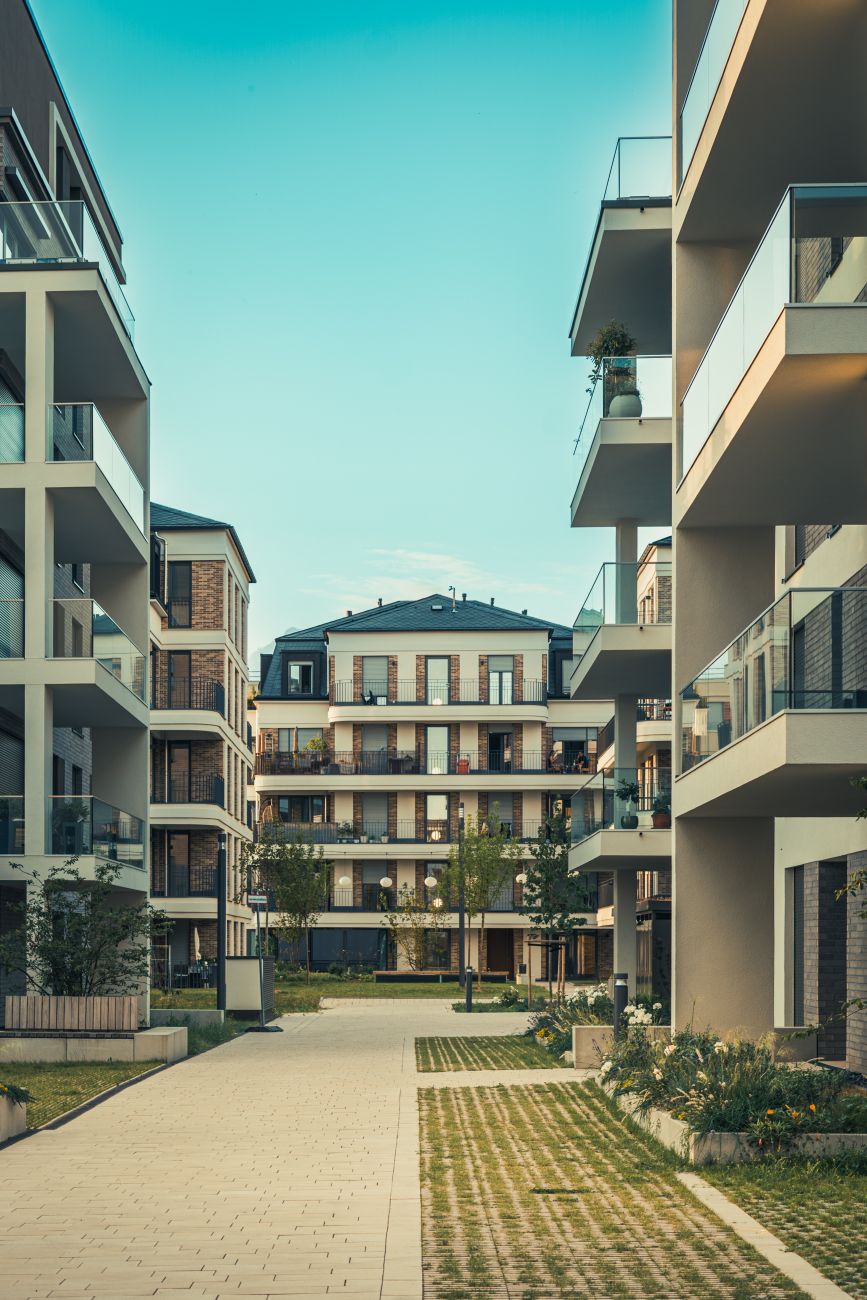 New high-rise residential building with a modern façade, balconies and wide windows